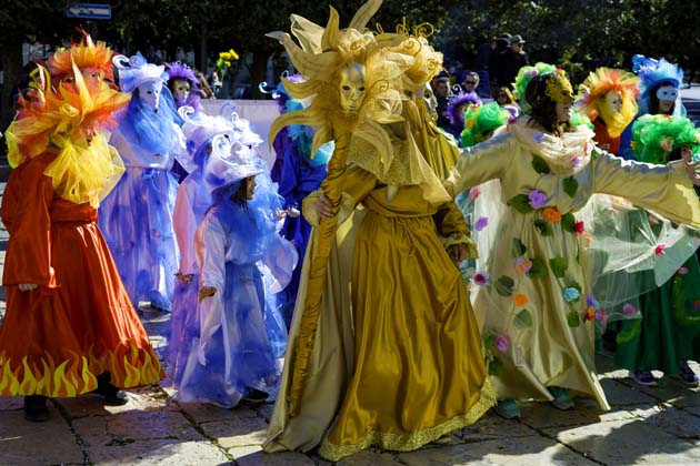 Gruppe beim Samba Karneval mit schönen, farbenfrohen Kostümen und phantasievollen Masken während des Karnevalumzugs in den Straßen einer Stadt 
